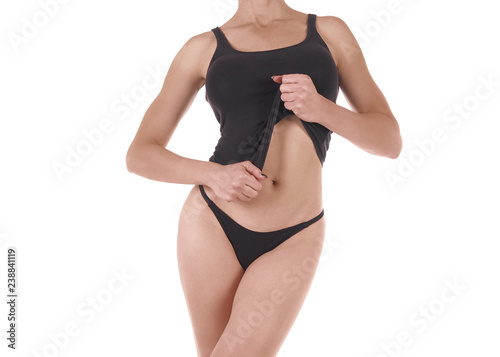 Female cropped fit body in black tank top and string panties, isolated on white.