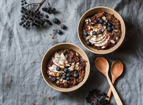 Chocolate overnight oat - healthy vegetarian breakfast on a grey background, top view. Flat lay, copy space