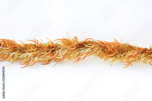 Gold colors bunch fur or Christmas tree tinsel garland on white background. Christmas and New year celebration.