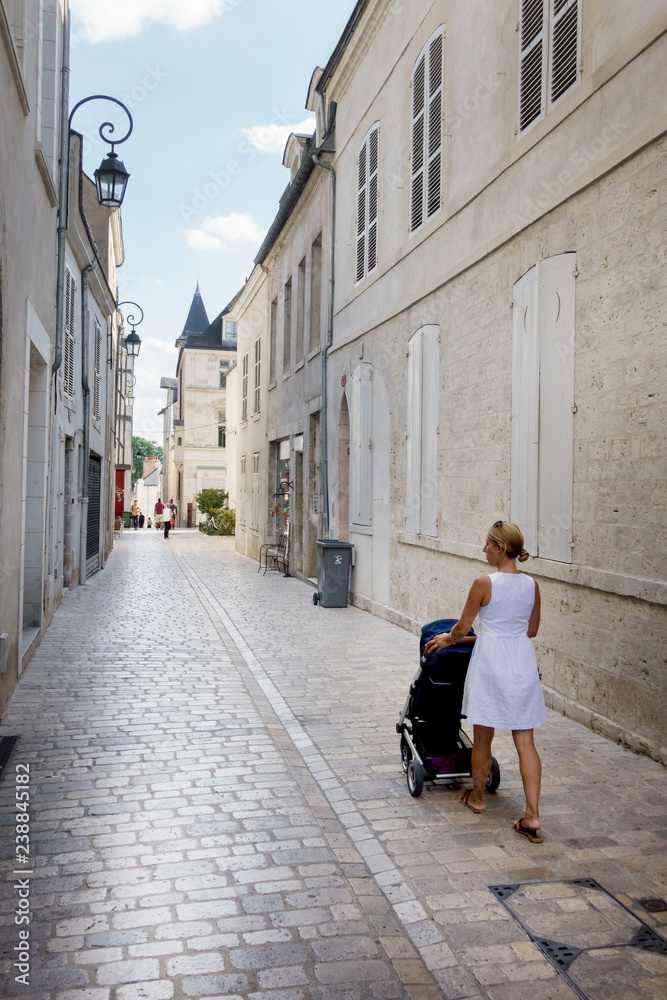 Mother pushing a stroller Mother pushing a stroller