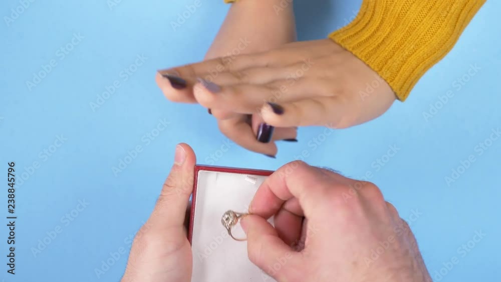 Man proposing with a wedding ring getting rejected. Top view from above. Man proposing with a wedding ring getting rejected. Top view from above.