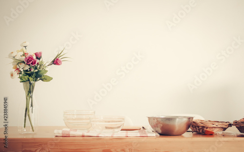Fruits tray, tablet and orange juice on table with white wall.