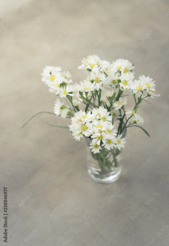 White flowers bunch in glass vase.