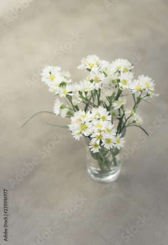 White flowers bunch in glass vase.