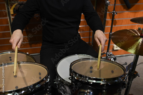  Professional drum set closeup. Man drummer with drumsticks playing drums and cymbals, on the live music rock concert or in recording studio 
