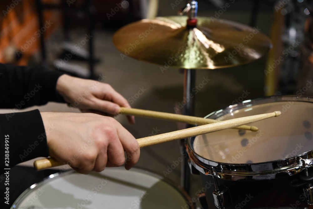 Professional drum set closeup. Man drummer with drumsticks playing drums and cymbals, on the live music rock concert or in recording studio Professional drum set closeup. Man drummer with drumsticks playing drums and cymbals, on the live music rock concert or in recording studio