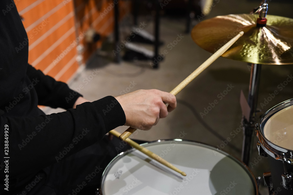  Professional drum set closeup. Man drummer with drumsticks playing drums and cymbals, on the live music rock concert or in recording studio   