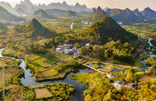 Sunset overlooking the Li River near Guilin, China. Li River is meandering through rice paddies and around striking green karst limestone hills.