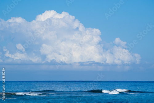 Waves of the Atlantic Ocean big beautiful clouds in the blue sky
