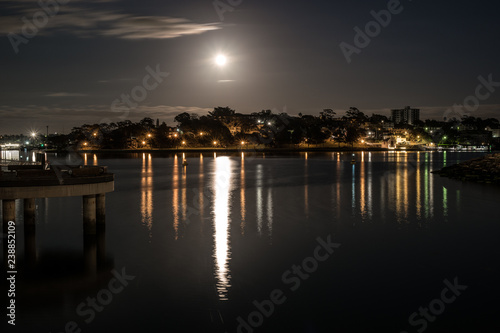 Full moon over houses and water