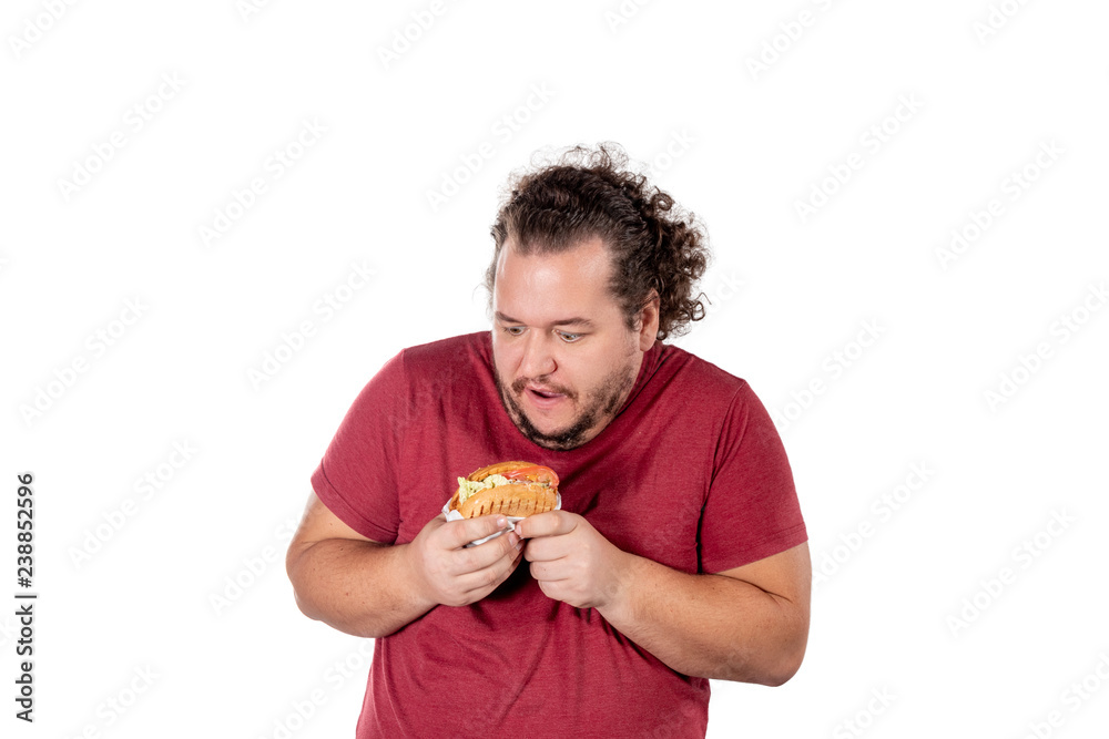 Funny fat man eating hamburger. Fast food, unhealty eat. Overweight and health problems Funny fat man eating hamburger. Fast food, unhealty eat. Overweight and health problems