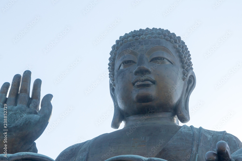 Fototapeta premium Closeup horizontal photo of Tian Tan Buddha, Lantau Island, Hong Kong. copy space in sky above buddha.