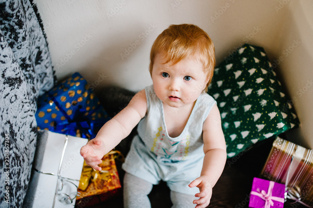 Portrait happy little girl with presents, sits on the background gifts. Festive birthday concept. baby on photo. infant. Women's Day, eighth of March. merry Christmas, happy holidays. new year. Portrait happy little girl with presents, sits on the background gifts. Festive birthday concept. baby on photo. infant. Women's Day, eighth of March. merry Christmas, happy holidays. new year.