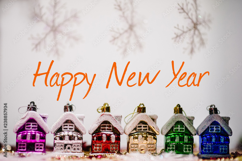 Festive background, text Happy New Year. Christmas tree decorations in form of colored houses, snowflakes. New Year city banners with traditional europe houses. Merry Christmas concept.