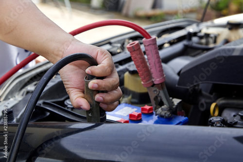 Hand of woman checking engine of car Maintenance