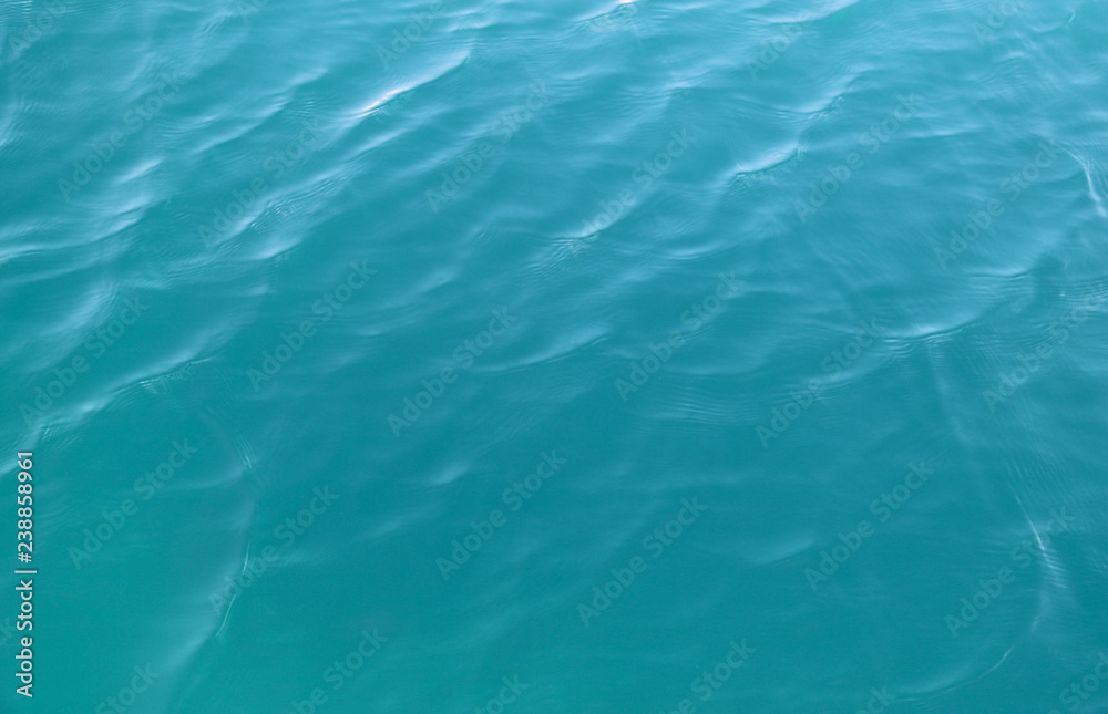 Closeup of clear blue sea water surface under sunlight. Natural art background and template. Closeup of clear blue sea water surface under sunlight. Natural art background and template.