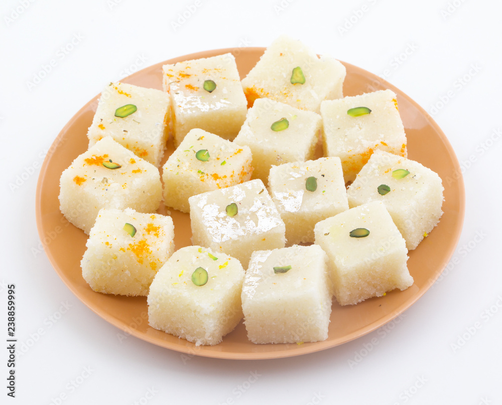 Indian Popular Sweet Food Khopara Pak or Coconut Burfi made up of Coconut, Milk And Sugar Isolated on White Background Indian Popular Sweet Food Khopara Pak or Coconut Burfi made up of Coconut, Milk And Sugar Isolated on White Background