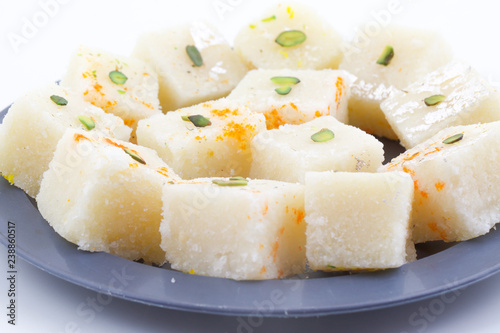 Indian Popular Sweet Food Khopara Pak or Coconut Burfi made up of Coconut, Milk And Sugar Isolated on White Background