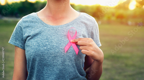 woman holding pink ribbon breast cancer awareness. concept healthcare photo