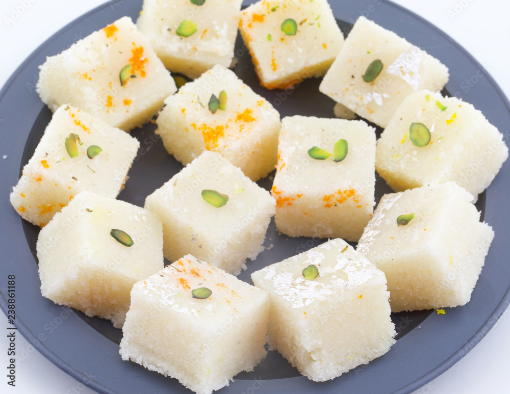 Indian Popular Sweet Food Khopara Pak or Coconut Burfi made up of Coconut, Milk And Sugar Isolated on White Background Indian Popular Sweet Food Khopara Pak or Coconut Burfi made up of Coconut, Milk And Sugar Isolated on White Background