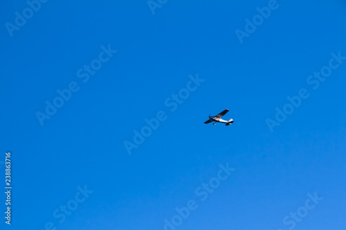 Free plane flying through blue clear sky in Austrian Zell am See