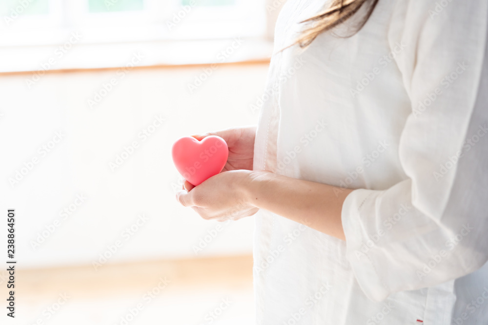 young asian woman holding heart symbol young asian woman holding heart symbol