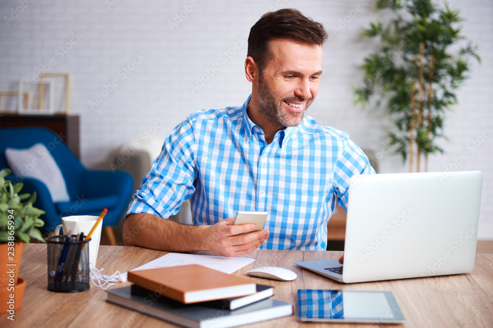 Smiling man working with laptop Smiling man working with laptop