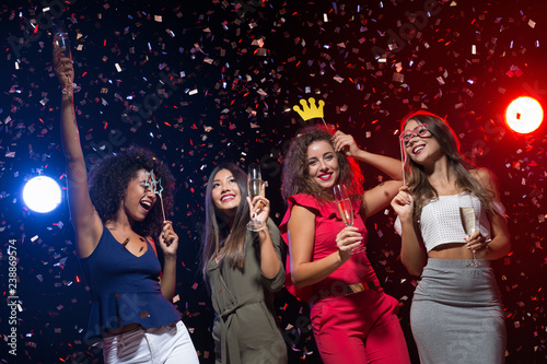 Happy women celebrating New Year at nightclub