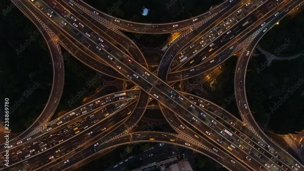 Panoramic vertical drone shot of traffic driving over modern illuminated intersection at night, famous Yan'an elevated highway and interchange in Shanghai, China Panoramic vertical drone shot of traffic driving over modern illuminated intersection at night, famous Yan'an elevated highway and interchange in Shanghai, China