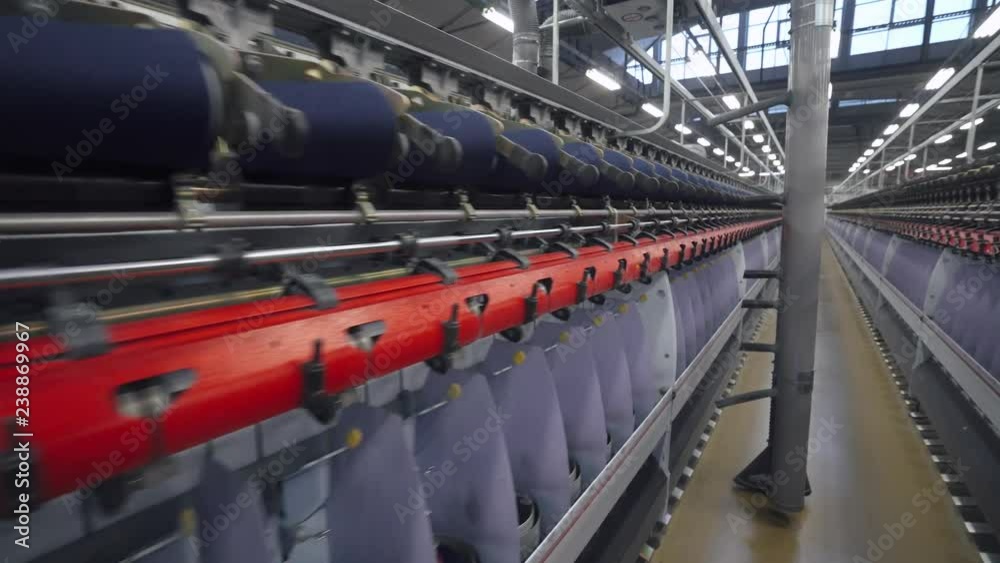Spinning factory, production of fabrics, thread of silk, linen, and synthetics, view of tunnels of production line on light industry. Spinning factory, production of fabrics, thread of silk, linen, and synthetics, view of tunnels of production line on light industry.