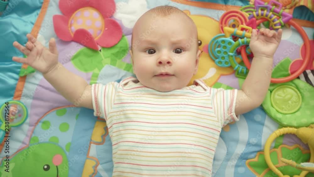 Happy baby emotion. Portrait of cute child lying back. Sweet kid enjoy world Happy baby emotion. Portrait of cute child lying back. Sweet kid enjoy world