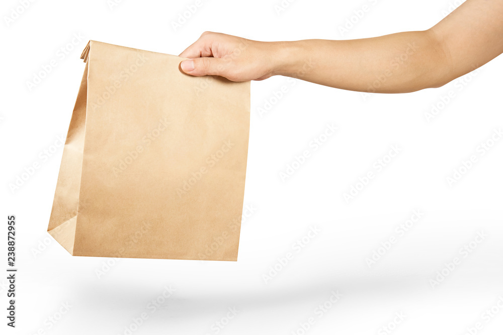 © runrun2 - Right hand holidng a brown paper bag isolated on white with clipping path.
