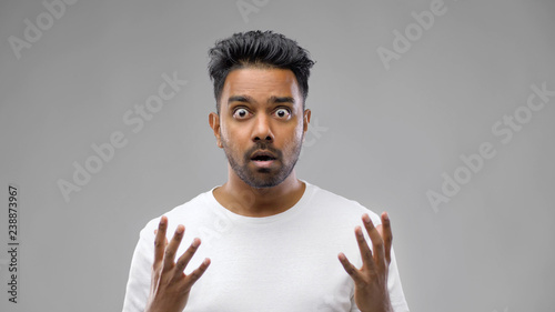 Foto emotion, expression and people concept - shocked indian man over grey background