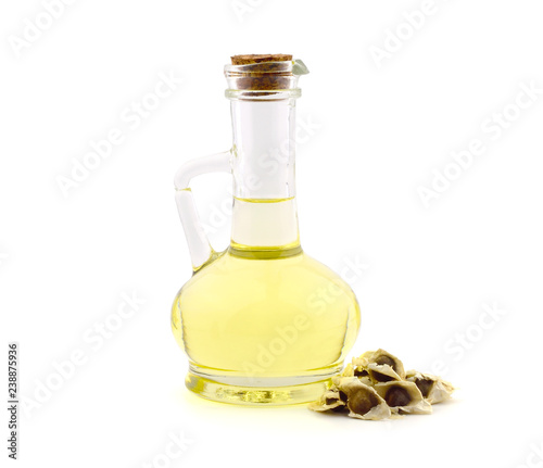 Moringa Oleifera Extract Oil Closeup with Seeds Isolated on White Background. Also Known as Drumstick Tree, Horseradish Tree, and Ben Oil or Benzoil Tree.