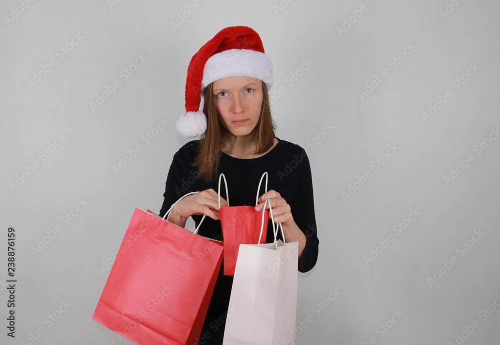 Christmas shopping, sale, loss concept. Puzzled, concerned upset woman checking shopping bags Christmas shopping, sale, loss concept. Puzzled, concerned upset woman checking shopping bags