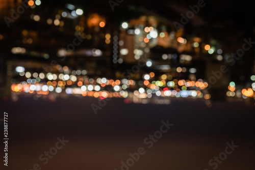 blurred buildings with bright bokeh lights at night