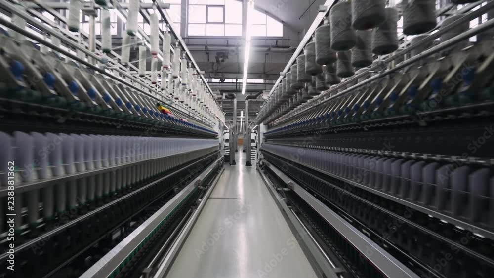 Spinning factory, production of fabrics, thread of silk, linen, and synthetics, view of tunnels of production line on light industry. Spinning factory, production of fabrics, thread of silk, linen, and synthetics, view of tunnels of production line on light industry.