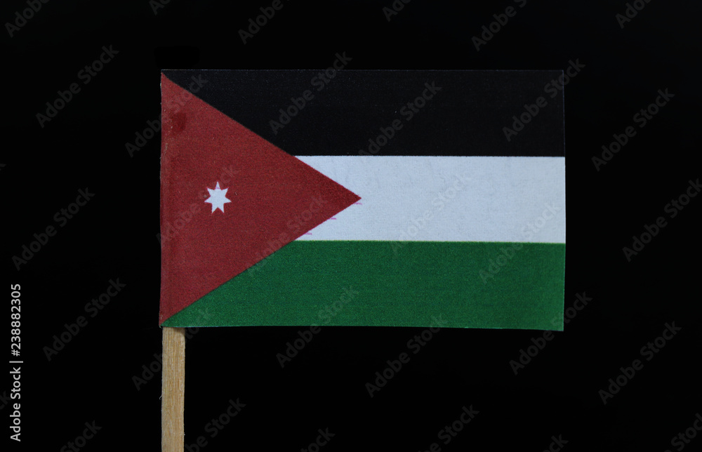 A official and unique flag of Jordan on toothpick on black background. A  horizontal triband of