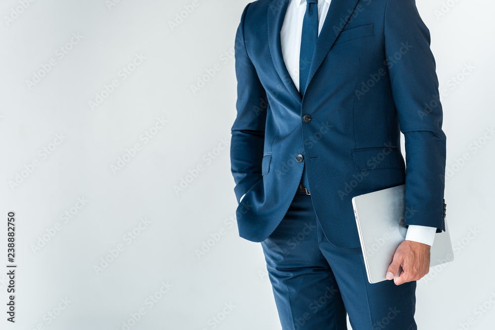 midsection of businessman standing with laptop isolated on white midsection of businessman standing with laptop isolated on white