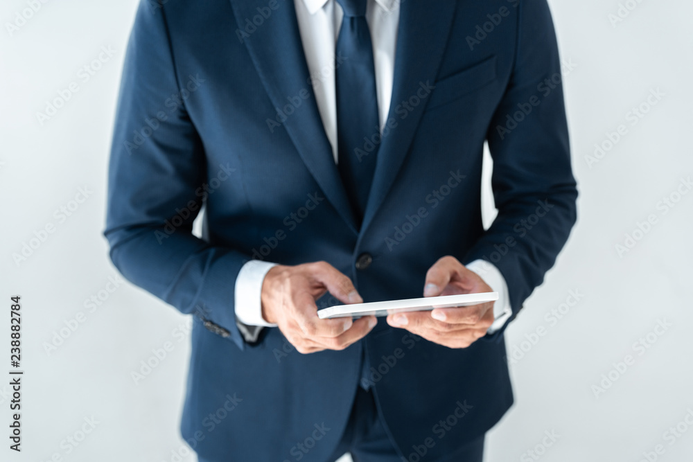 cropped image of businessman using tablet isolated on white cropped image of businessman using tablet isolated on white