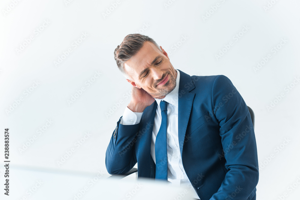 cheerful tired businessman touching neck isolated on white cheerful tired businessman touching neck isolated on white