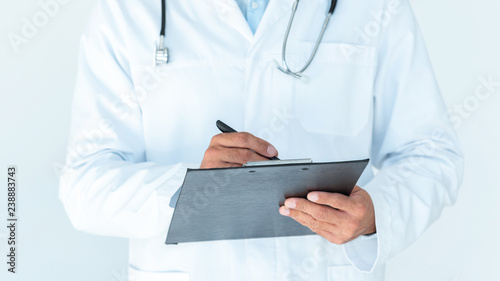 cropped image of doctor in white coat writing something in clipboard isolated on white