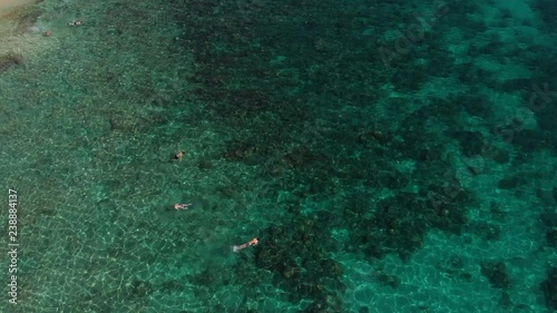 aerial view of people snorkeling in clear waters of archipelago of Bacuit, Philippines