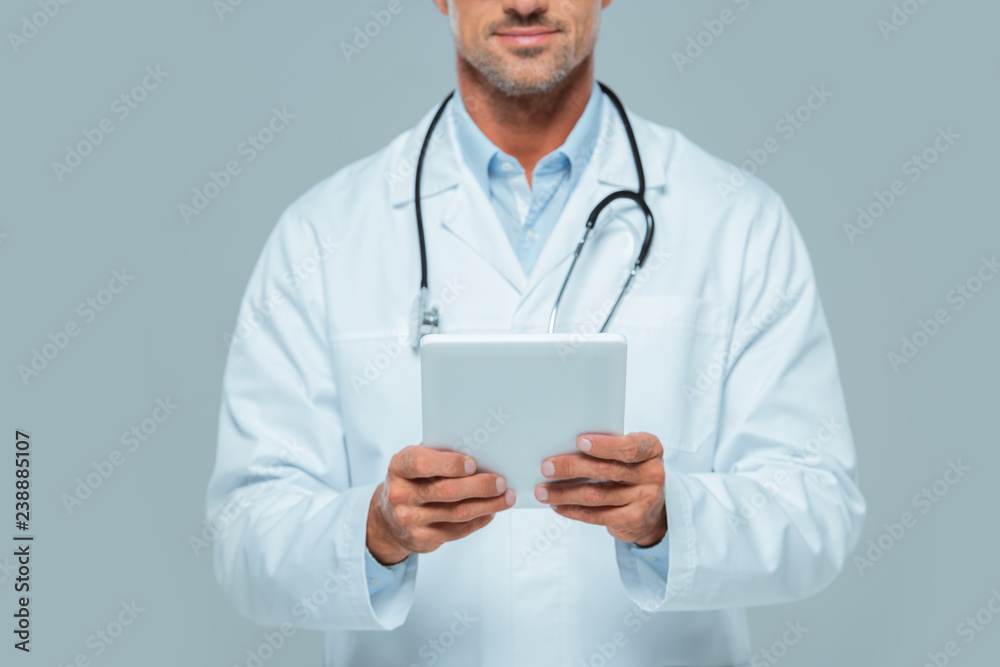cropped image of doctor in white coat holding tablet isolated on white cropped image of doctor in white coat holding tablet isolated on white