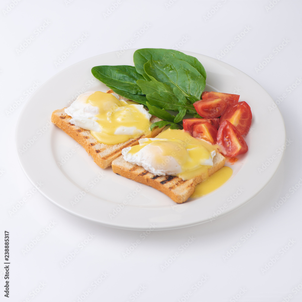 Plate of breakfast with fried eggs, toasts, tomato isolated on white backgound Plate of breakfast with fried eggs, toasts, tomato isolated on white backgound