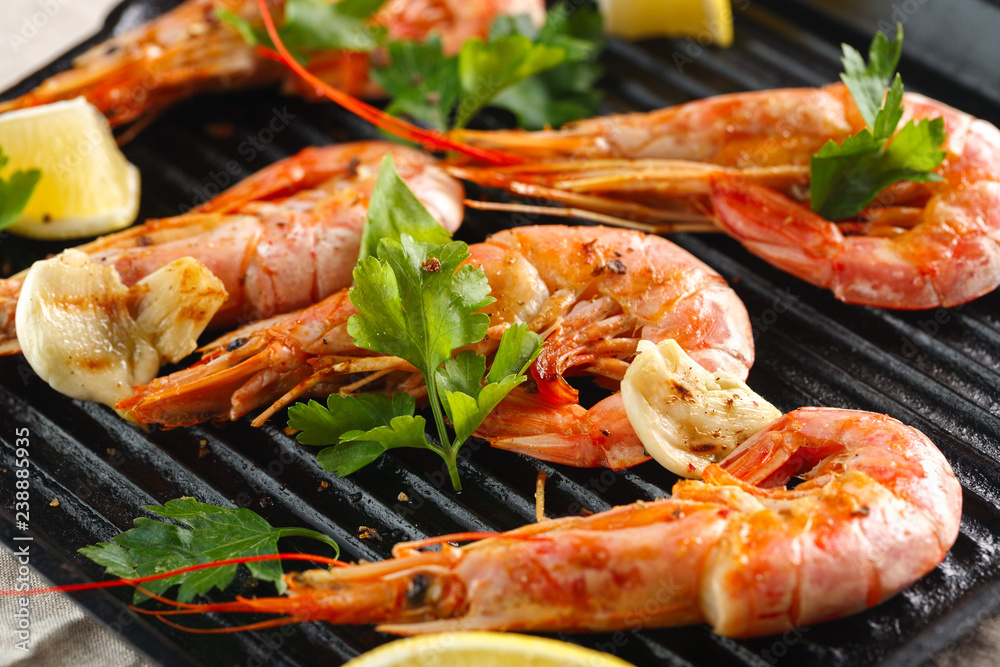 Grilled shrimps with spice, garlic and lemon. Grilled seafood. Langoustines. Grilled shrimps with spice, garlic and lemon. Grilled seafood. Langoustines.