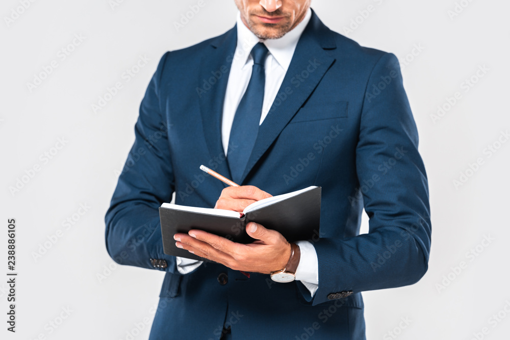 cropped image of businessman writing something in notebook isolated on white cropped image of businessman writing something in notebook isolated on white