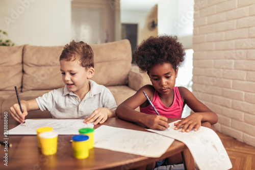 Multiracial children drawing at home