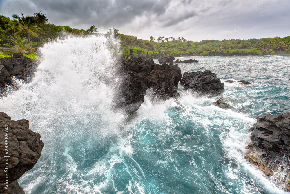 Waves are Crashing on the Bay at Black Sands Beach in Waianapanapa State Park Waves are Crashing on the Bay at Black Sands Beach in Waianapanapa State Park