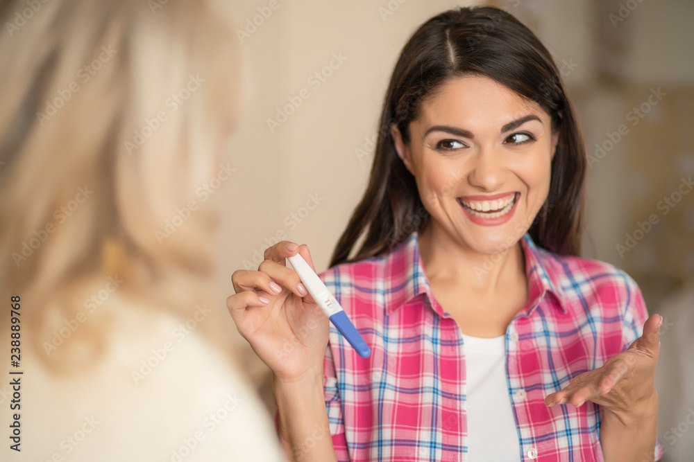 Showing two stripes of pregnancy test. Happiness Showing two stripes of pregnancy test. Happiness